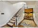 Elegant stairway with runner, white railings, and decorative table with lamps at 2648 Rivers Nw Rd, Atlanta, GA 30305