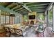 Cozy sunroom with brick accents, comfortable seating, fireplace, and views of nature at 2648 Rivers Nw Rd, Atlanta, GA 30305