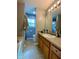 Bathroom with a large vanity and mirror next to a toilet and combination tub/shower unit at 305 Pleasant Forest Dr, Temple, GA 30179