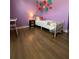 Charming bedroom with wood-look floors features floral decor and lots of natural light at 305 Pleasant Forest Dr, Temple, GA 30179
