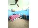 Bright bedroom featuring a ceiling fan, a desk, and a Captain America comforter set at 305 Pleasant Forest Dr, Temple, GA 30179
