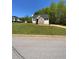 Scenic property showcases a well-kept lawn, inviting curb appeal, and ample space at 305 Pleasant Forest Dr, Temple, GA 30179