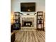 Close-up of a stone fireplace with decorative shelves and sleek, modern flooring at 305 Pleasant Forest Dr, Temple, GA 30179