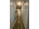 Long hallway with wood-look floors, closet space, and neutral paint at 305 Pleasant Forest Dr, Temple, GA 30179