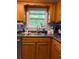 Close up of kitchen sink featuring shaker-style cabinets, modern finishes, and large window at 305 Pleasant Forest Dr, Temple, GA 30179