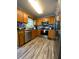 Well-lit kitchen features wood cabinets, stainless steel appliances and modern finishes at 305 Pleasant Forest Dr, Temple, GA 30179