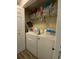 Conveniently located laundry room with washer, dryer, wire shelves and storage space at 305 Pleasant Forest Dr, Temple, GA 30179