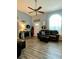 Well-lit living area includes a leather sofa, decorative accents, and durable flooring at 305 Pleasant Forest Dr, Temple, GA 30179