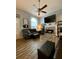 Comfortable living room featuring a stone fireplace, large windows, and neutral wall color at 305 Pleasant Forest Dr, Temple, GA 30179