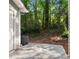 View of a concrete patio overlooking a grassy backyard space with mature trees for extra privacy at 4643 Grand Central Pkwy, Decatur, GA 30035