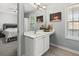 Well-lit bathroom with a white vanity, framed mirror, and view to bedroom at 4643 Grand Central Pkwy, Decatur, GA 30035
