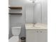 Bathroom with a white vanity and a toilet with modern floating shelves at 4643 Grand Central Pkwy, Decatur, GA 30035