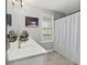 Bright bathroom featuring a white vanity, modern fixtures, and a shower with a white curtain at 4643 Grand Central Pkwy, Decatur, GA 30035