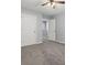 Neutral-toned bedroom boasts plush carpet, a ceiling fan, and easy access to the hallway at 4643 Grand Central Pkwy, Decatur, GA 30035
