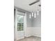Dining area with stylish lighting, wainscoting details, and a large window for natural light at 4643 Grand Central Pkwy, Decatur, GA 30035