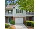 Charming townhome featuring a one-car garage, balcony, and a well-maintained lawn at 4643 Grand Central Pkwy, Decatur, GA 30035