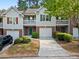 Charming townhome with brick accents, a one-car garage, and a well-maintained landscaped front yard at 4643 Grand Central Pkwy, Decatur, GA 30035