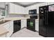 Well-equipped kitchen featuring white cabinets, black appliances and light countertops at 4643 Grand Central Pkwy, Decatur, GA 30035