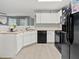 Bright kitchen with white cabinets, modern appliances, and neutral countertops at 4643 Grand Central Pkwy, Decatur, GA 30035