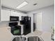 Well-equipped kitchen featuring white cabinets, black appliances, and eat-in area at 4643 Grand Central Pkwy, Decatur, GA 30035