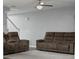 Living room featuring a ceiling fan, comfortable seating, neutral walls, and a staircase at 4643 Grand Central Pkwy, Decatur, GA 30035