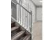Carpeted staircase with white railing and spindles leading to the upper level with access to several rooms at 4643 Grand Central Pkwy, Decatur, GA 30035