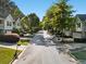 Scenic street view of well-maintained townhomes with manicured lawns, sidewalks, and mature trees at 4643 Grand Central Pkwy, Decatur, GA 30035