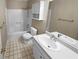 Bathroom with white cabinets, countertop, and combination shower and tub at 3510 Beaver Cove Rd, Cumming, GA 30041