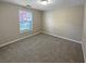 Bedroom featuring a bright window and neutral carpet and paint at 3510 Beaver Cove Rd, Cumming, GA 30041