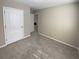 Bedroom featuring plush carpeting, neutral walls, and a glimpse into the home's interior spaces at 3510 Beaver Cove Rd, Cumming, GA 30041