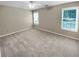 Neutral bedroom featuring two windows and neutral carpet at 3510 Beaver Cove Rd, Cumming, GA 30041