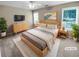 Bright staged bedroom with a large bed, dresser, and natural light at 3510 Beaver Cove Rd, Cumming, GA 30041