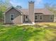 Rear exterior view of a home featuring a well-maintained lawn and neutral siding at 3510 Beaver Cove Rd, Cumming, GA 30041