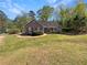 Charming one-story home with a well-manicured front yard and mature trees at 3510 Beaver Cove Rd, Cumming, GA 30041