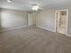 Large main bedroom featuring neutral carpet and paint, adjacent to the ensuite bathroom at 3510 Beaver Cove Rd, Cumming, GA 30041