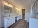 Bathroom featuring double vanity with marble countertop, modern fixtures, and a glass enclosed shower at 1703 Feast Ct, Cumming, GA 30040