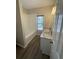 Bright bathroom featuring a double sink vanity with granite countertop and bathtub with white tile surround at 1703 Feast Ct, Cumming, GA 30040