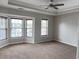 Bedroom with a trey ceiling, a ceiling fan, neutral carpeting, and a bay window with blinds at 1703 Feast Ct, Cumming, GA 30040