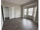 Spacious bedroom with neutral paint, a bay window with blinds, and a closet with bifold doors at 1703 Feast Ct, Cumming, GA 30040