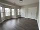Bedroom featuring neutral paint, a bay window with blinds, two closets with bifold doors, and neutral carpeting at 1703 Feast Ct, Cumming, GA 30040