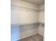 Walk-in closet complete with shelving, providing ample storage space for your wardrobe and accessories at 1703 Feast Ct, Cumming, GA 30040