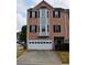 Charming brick townhome with attached garage and classic black shutters offers curb appeal at 1703 Feast Ct, Cumming, GA 30040