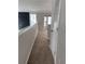 Hallway featuring neutral paint, neutral carpeting, and a view to the downstairs living room with lots of windows at 1703 Feast Ct, Cumming, GA 30040