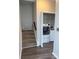 Hallway featuring a carpeted staircase leading to a laundry area with a white washer and dryer at 1703 Feast Ct, Cumming, GA 30040