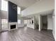 Open concept living room with lots of natural light, a fireplace, and modern light fixture at 1703 Feast Ct, Cumming, GA 30040