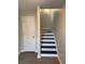 Interior staircase with newly stained steps next to a white door at 1703 Feast Ct, Cumming, GA 30040