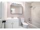 Bathroom featuring modern vanity, white marble shower surround, and tub combo at 1703 Laurel Creek Cir, Lithonia, GA 30058