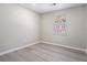 This bedroom has gray walls, gray vinyl floors, and a window at 1703 Laurel Creek Cir, Lithonia, GA 30058