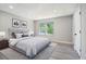 This bedroom features a large bed, gray walls, gray vinyl floors, and a window view of the outdoors at 1703 Laurel Creek Cir, Lithonia, GA 30058