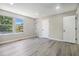 This bedroom has gray walls, gray vinyl floors, a window, and two white doors at 1703 Laurel Creek Cir, Lithonia, GA 30058